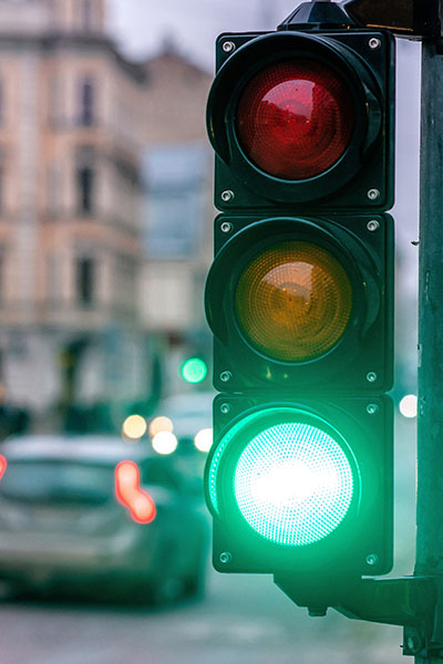 A city crossing with a semaphore. Green light in semaphore